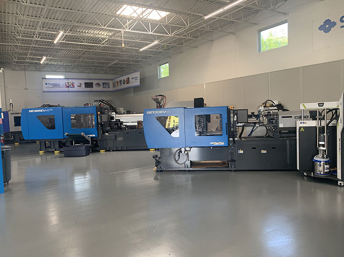 The Sumitomo show room with working injection molding machines